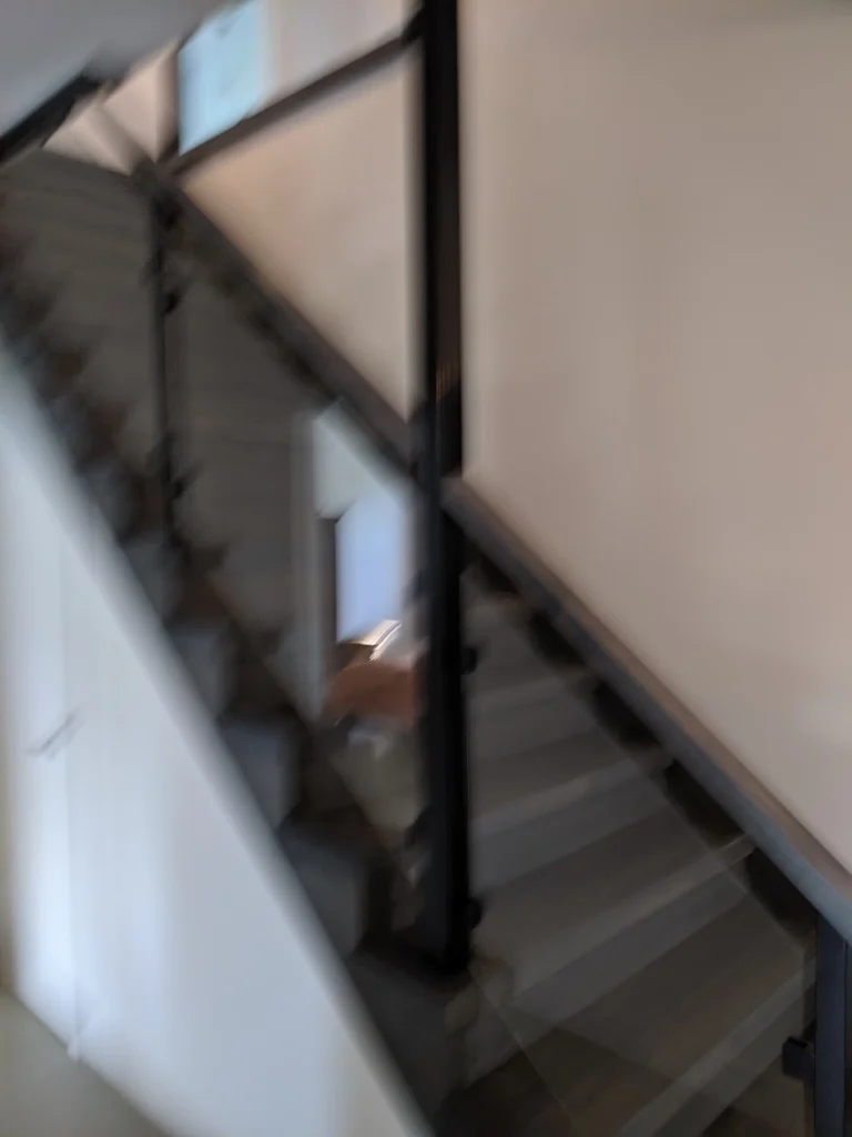Escalier tournant gris-brun à garde-corps de verre et structure d'acier à Longueuil (vue 5)