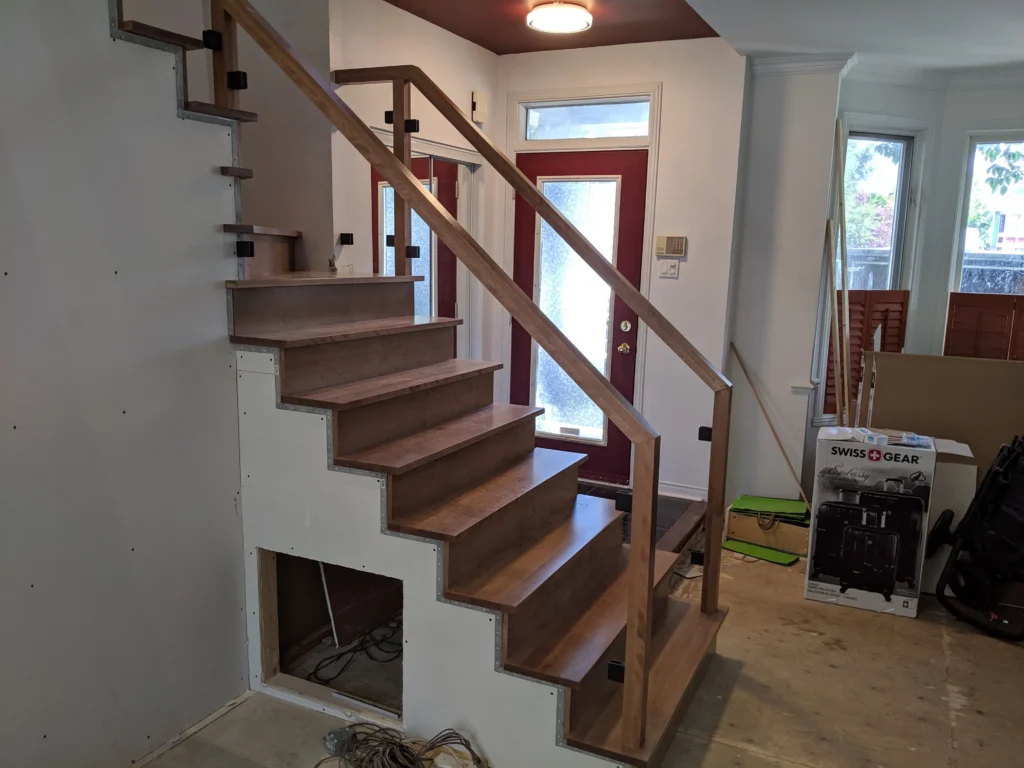Escalier tournant de bois franc au ton miel et garde-corps de verre à Boucherville (vue 3)