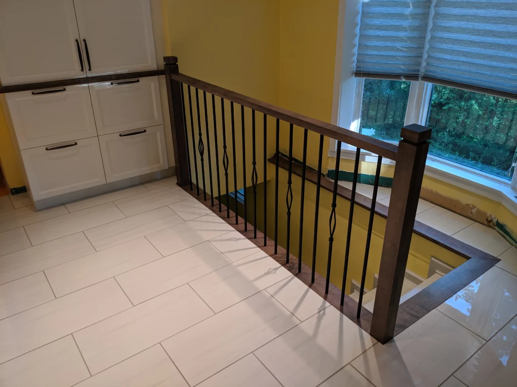 Escalier à garde-corps de bois foncé et barreaux de métal noir décoratifs