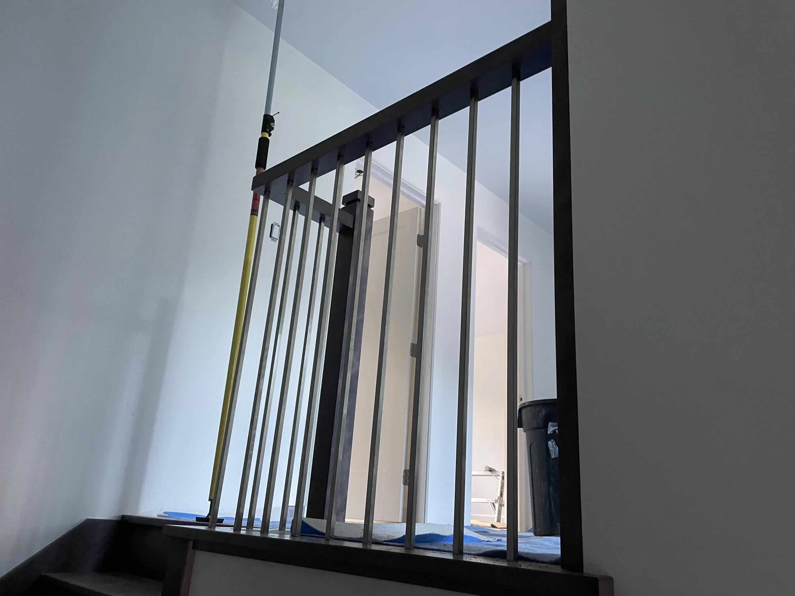 Straight wood staircase stained grey-brun between walls — vue principale