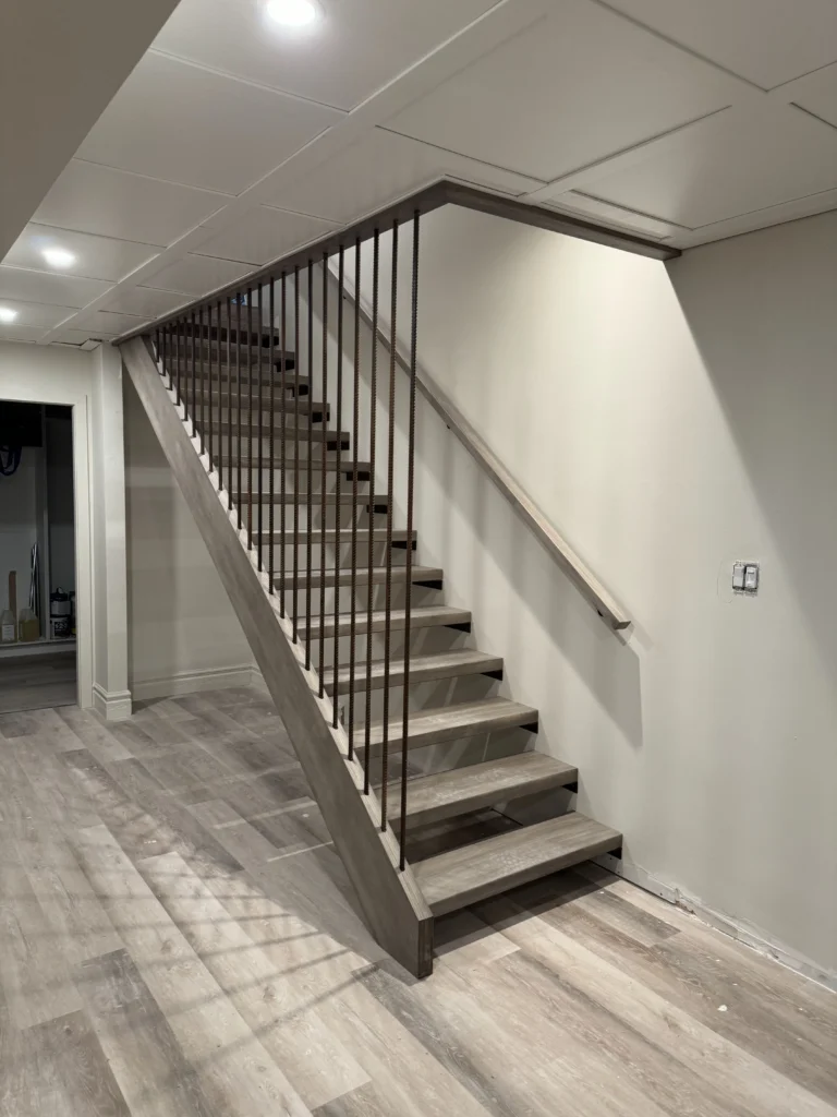 Escalier en bois grisé vu depuis la pièce du sous-sol