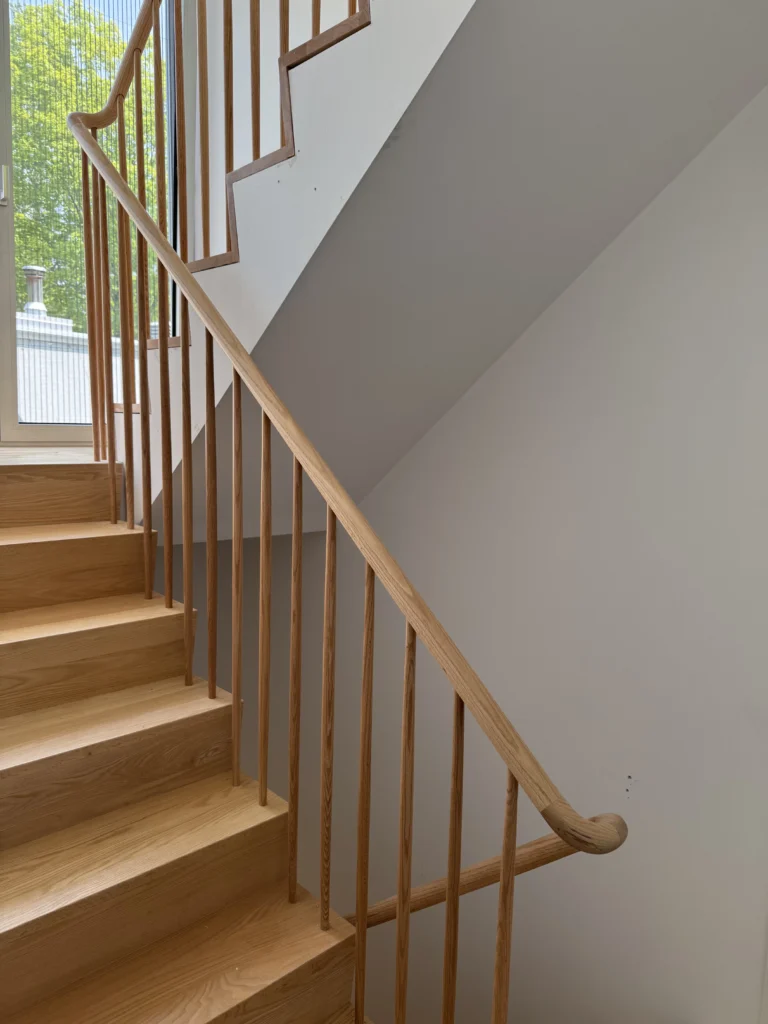 Escalier tournant en frêne clair à barreaux ronds fuselés