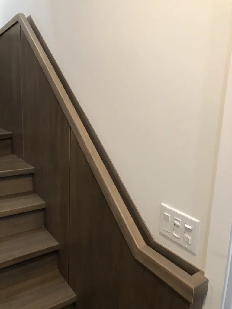 Escalier droit avec mur bahut de bois et main courante intégrée