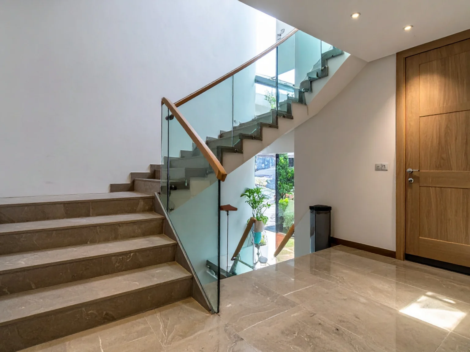 Tempered glass guard running alongside an interior hardwood flight
