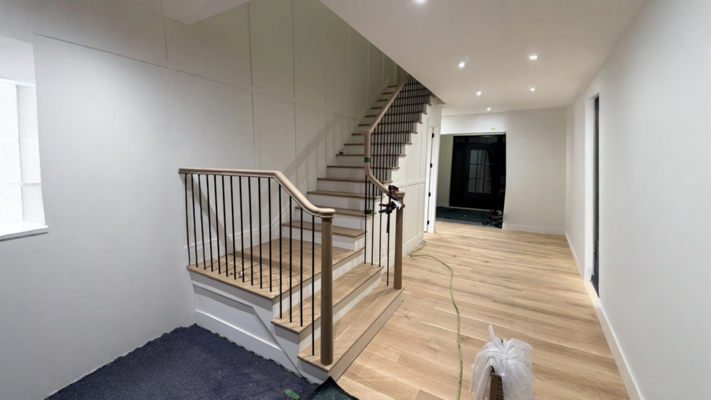 Winder staircase in white oak with black metal balusters and wood post