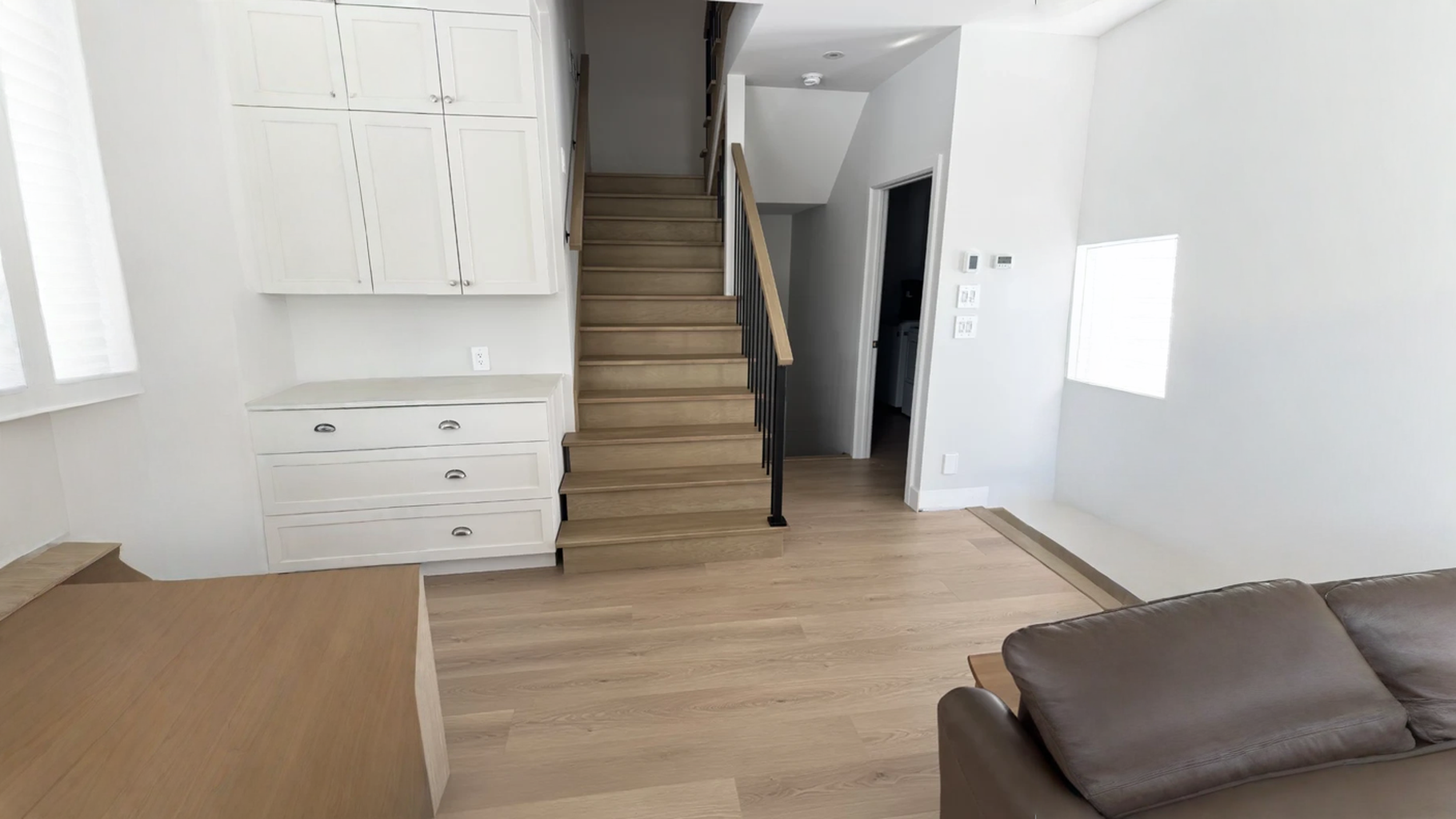 Escalier droit en chêne blanc à barreaux d’acier noir et cuisine attenante — vue principale
