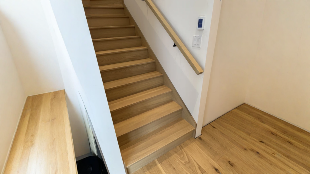 Escalier droit en chêne blanc entre deux murs à main courante murale