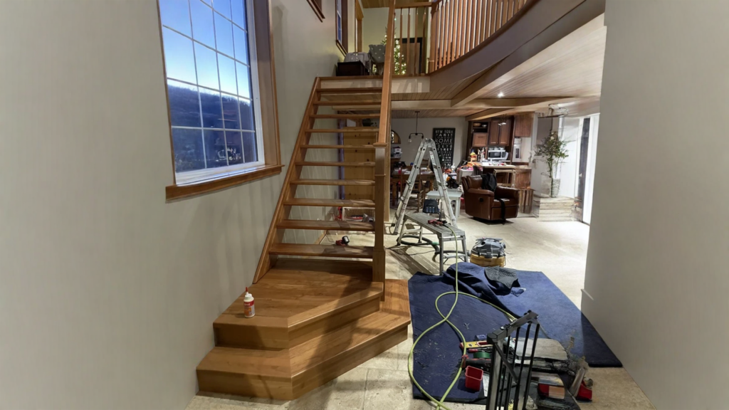 Straight staircase to risers open leading to a wooden curved gallery