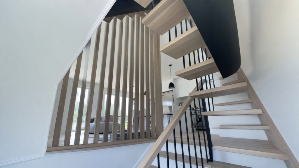 Floating staircase in white oak with wood claustry and black steel structure